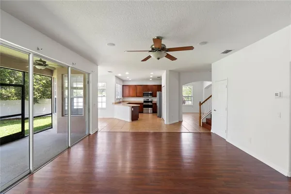a view of a living room a hardwood floor and a ceiling fan