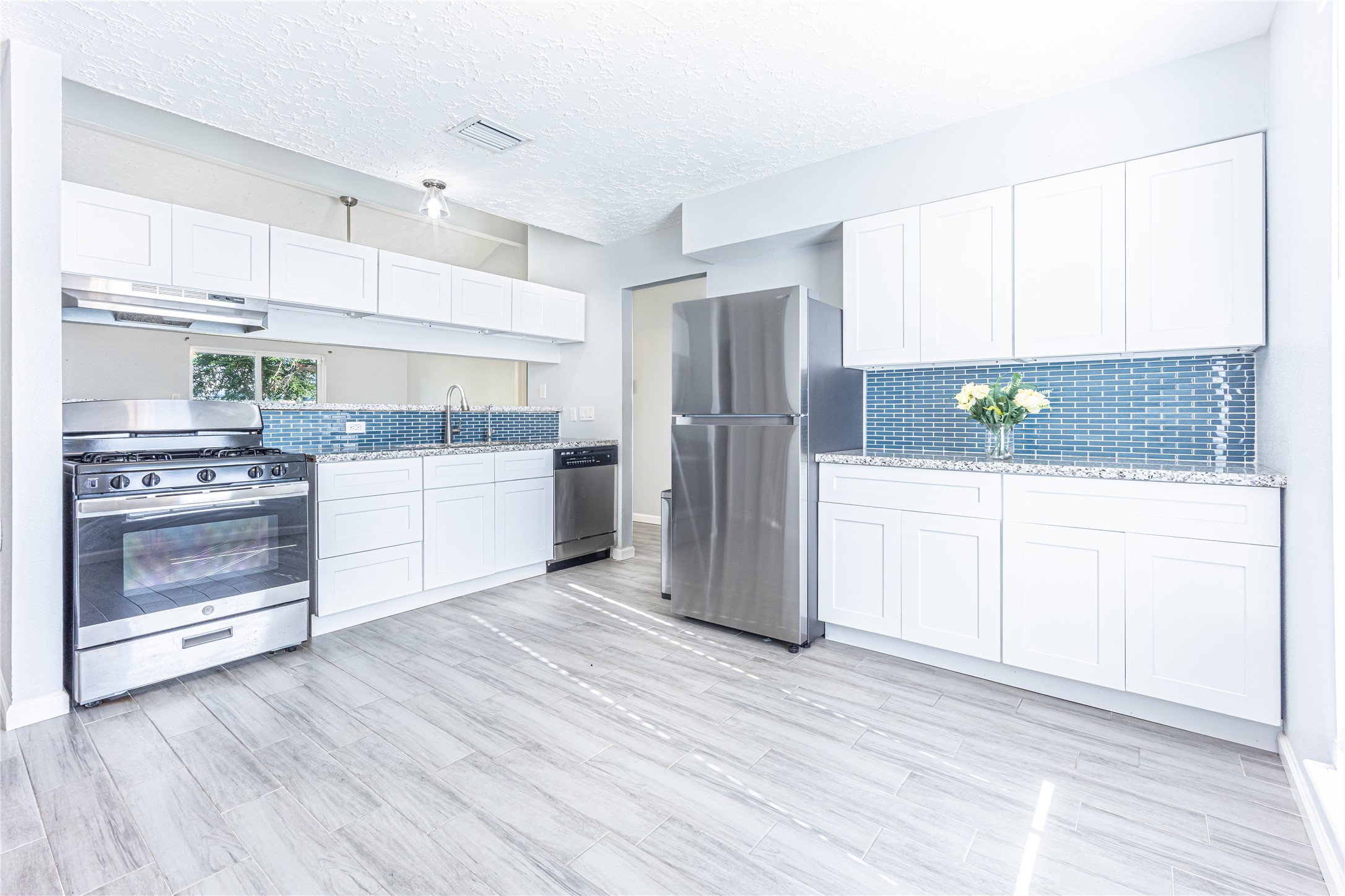 1010 Woodbridge Avenue Pearland, TX 77584 - Photo 2 of 14 a kitchen with stainless steel appliances a refrigerator sink and cabinets