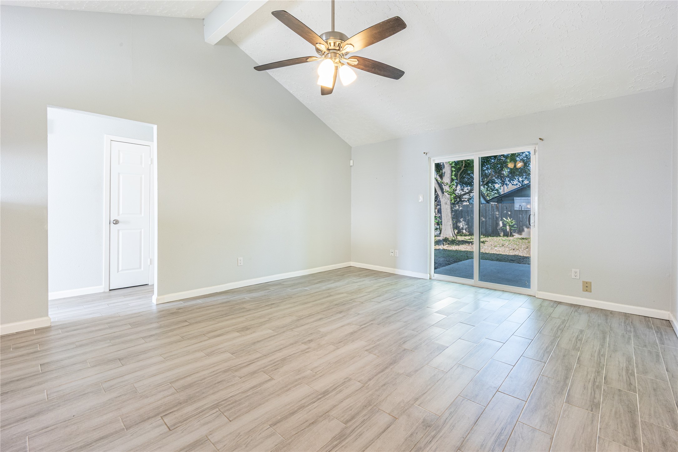 1010 Woodbridge Avenue Pearland, TX 77584 - Photo 3 of 14 an empty room with wooden floor and windows