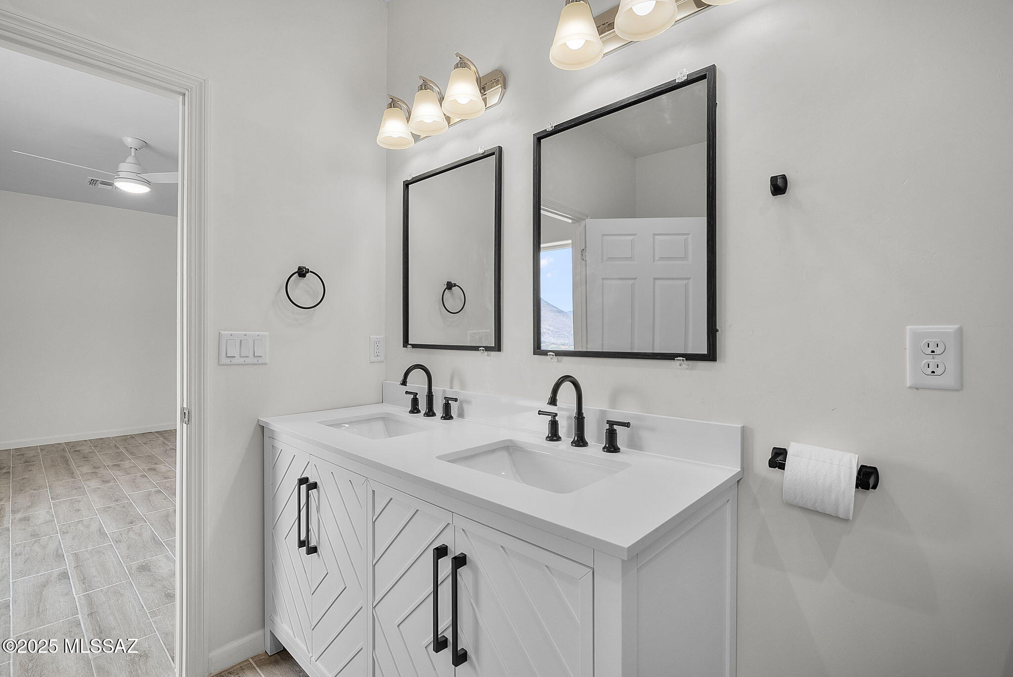 1895 Roma Court Rio Rico, AZ 85648 - Photo 22 of 42 a bathroom with a sink vanity and mirror