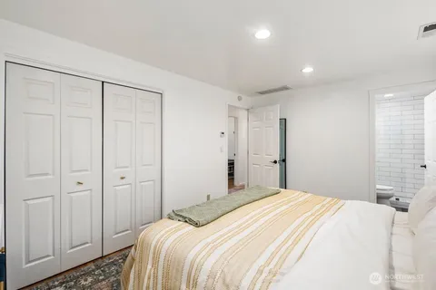 a bedroom with a bed and a closet