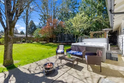 a view of backyard with seating area and trees