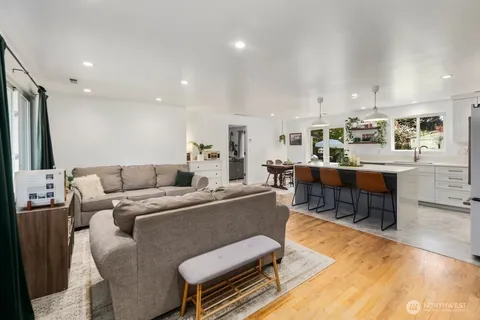 a living room with furniture and a dining table with kitchen view