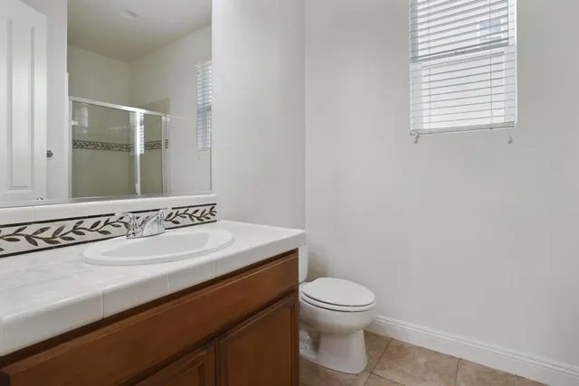 a view of an empty room with a fireplace and a window