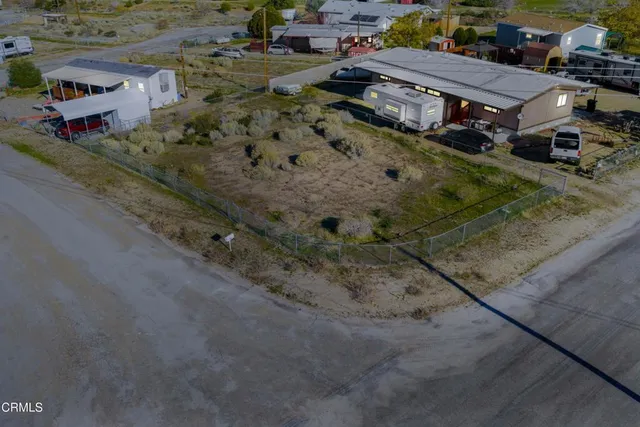 an aerial view of a houses with a yard