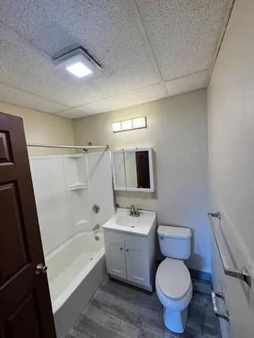 a bathroom with a toilet sink a mirror a bathtub and vanity