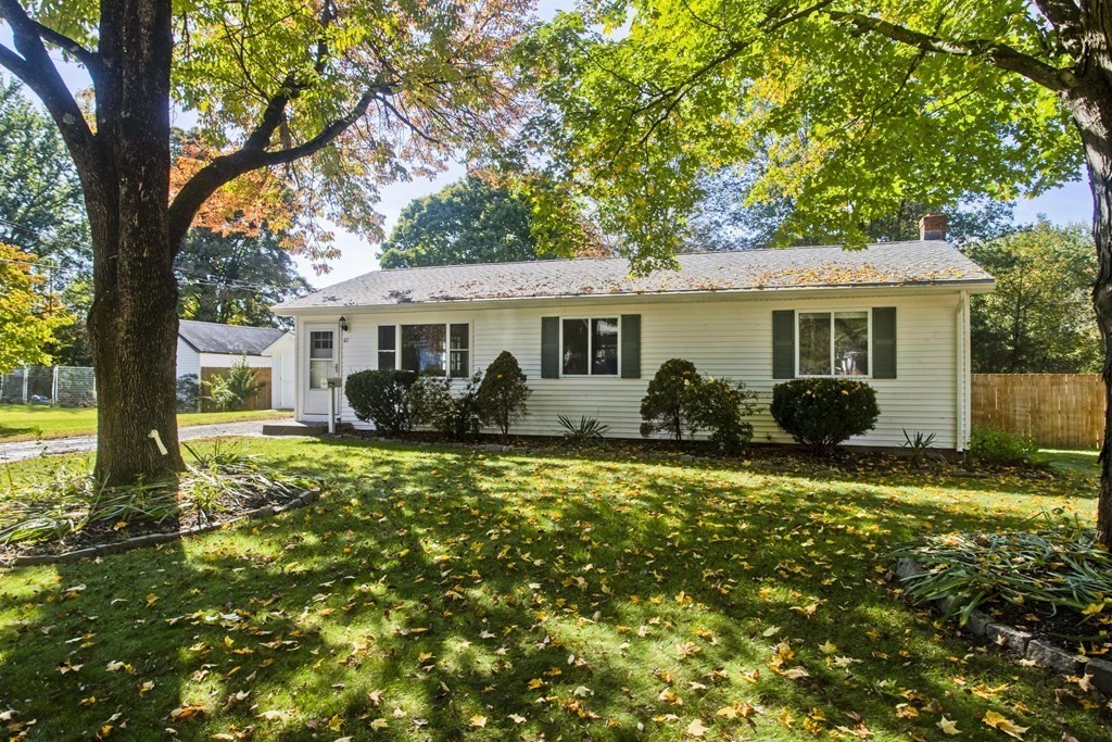 a view of a house with backyard sitting area and garden
