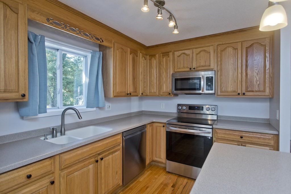 61 Arbor Road Enfield, CT 06082 - Photo 12 of 39 a kitchen with sink a microwave and cabinets