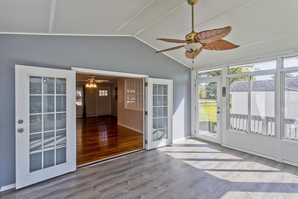 61 Arbor Road Enfield, CT 06082 - Photo 16 of 39 a view of a livingroom with wooden floor and a ceiling fan