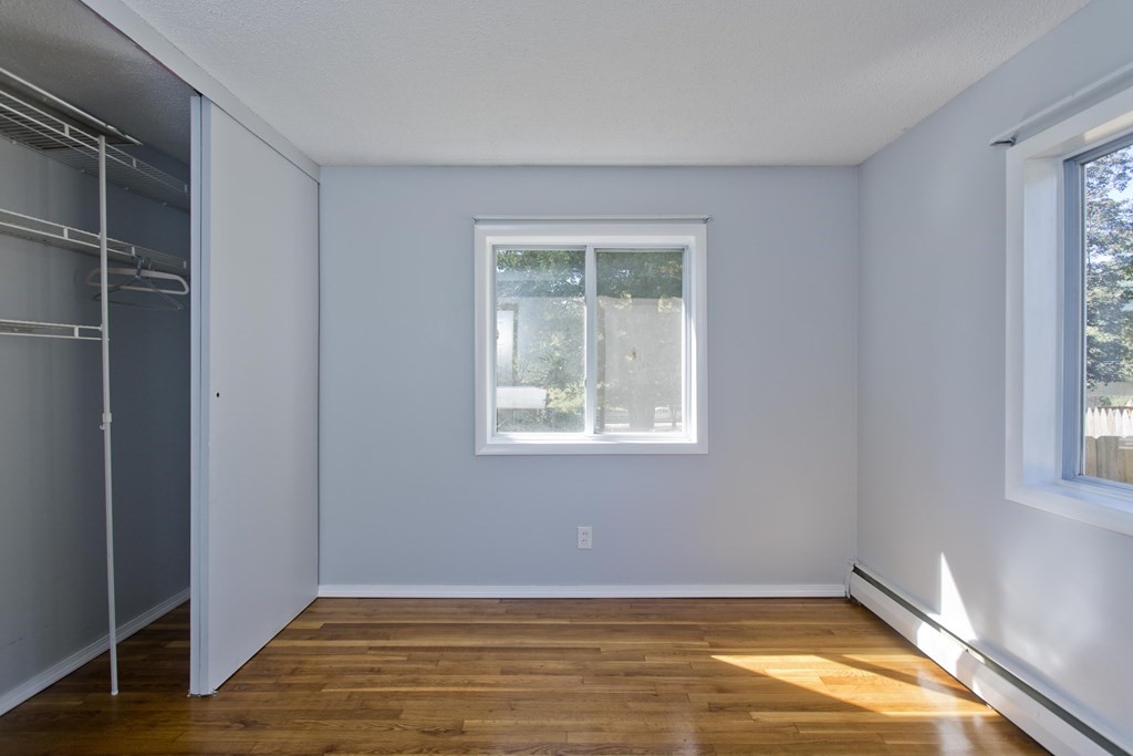 61 Arbor Road Enfield, CT 06082 - Photo 22 of 39 a view of an empty room with wooden floor and a window