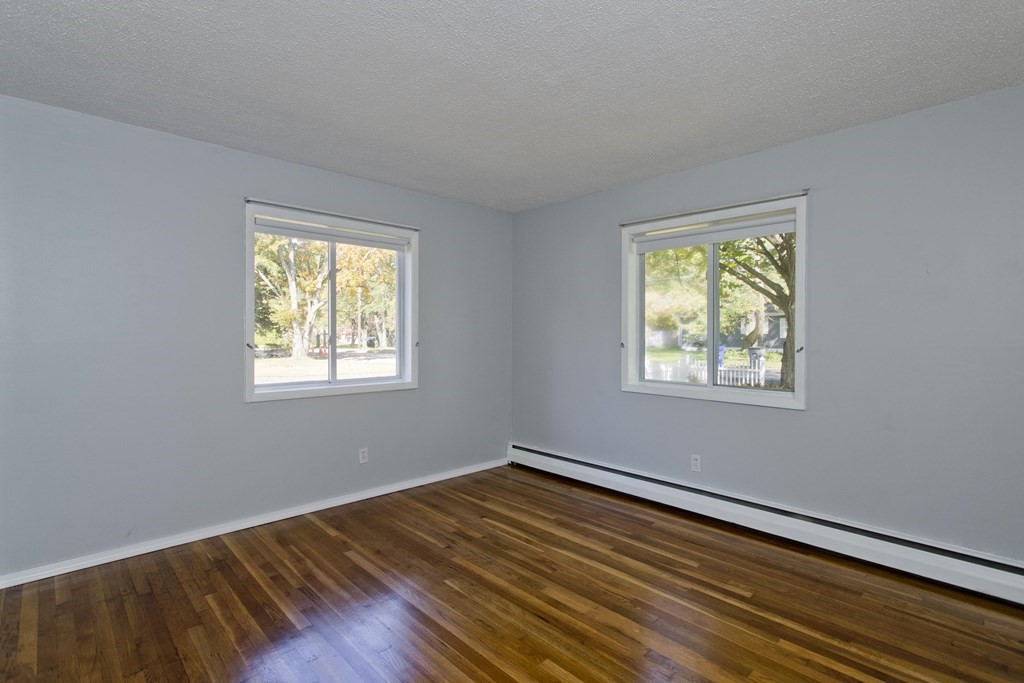 61 Arbor Road Enfield, CT 06082 - Photo 23 of 39 a view of an empty room with wooden floor and a window