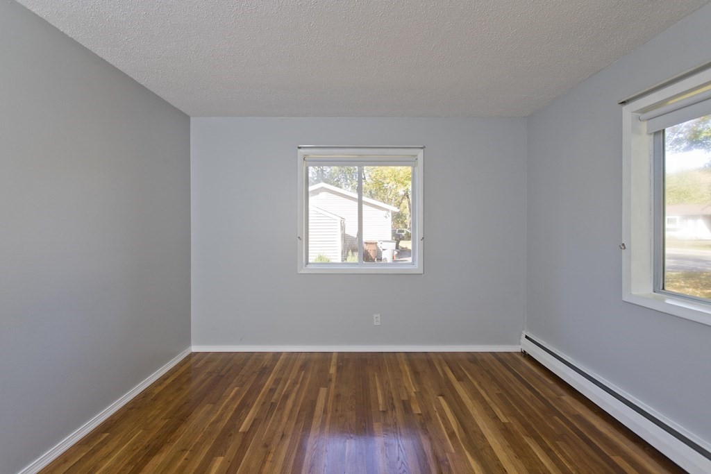 61 Arbor Road Enfield, CT 06082 - Photo 24 of 39 a view of an empty room with wooden floor and a window