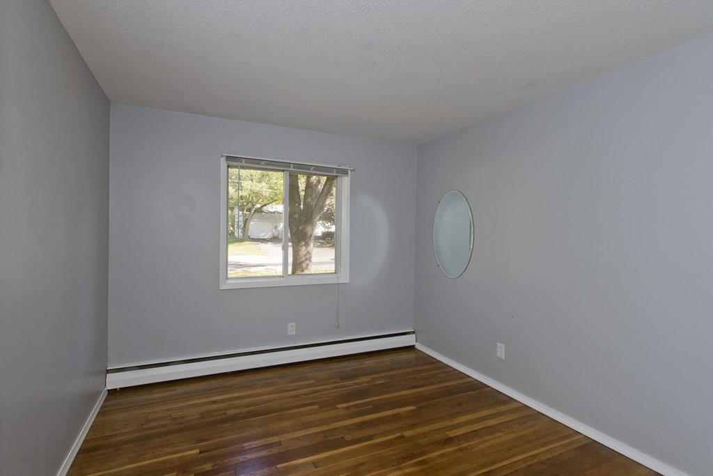 61 Arbor Road Enfield, CT 06082 - Photo 26 of 39 an empty room with wooden floor and windows