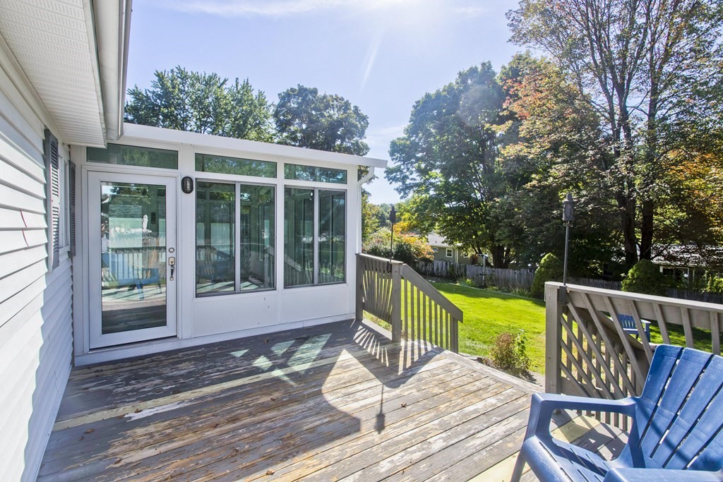 61 Arbor Road Enfield, CT 06082 - Photo 35 of 39 a view of a deck with a chair and floor to ceiling window