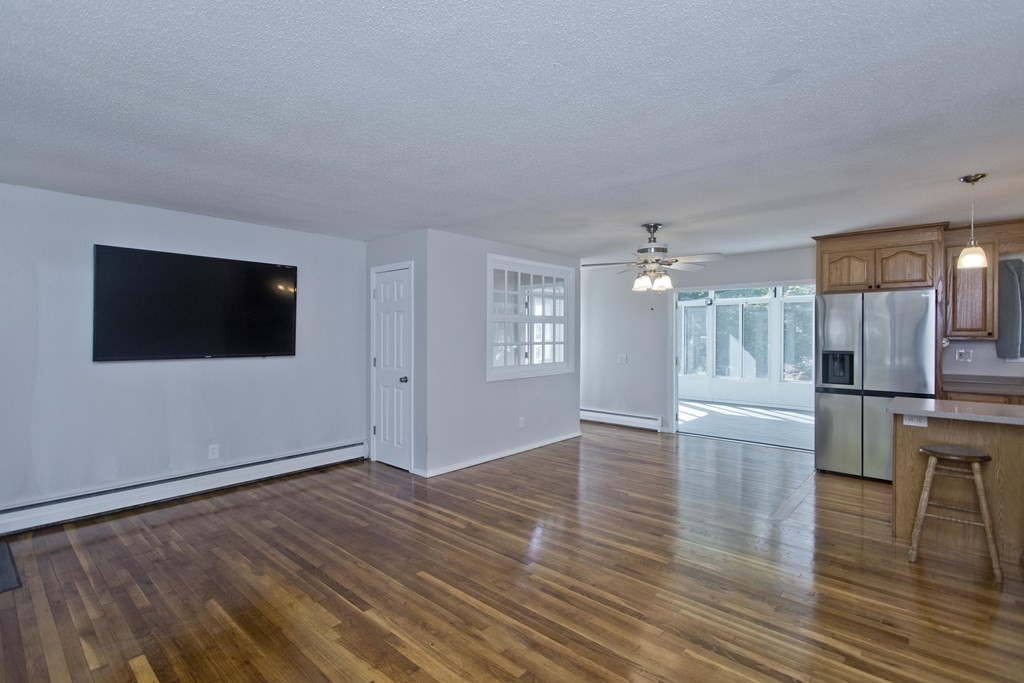 61 Arbor Road Enfield, CT 06082 - Photo 5 of 39 a view of a livingroom with wooden floor and kitchen space