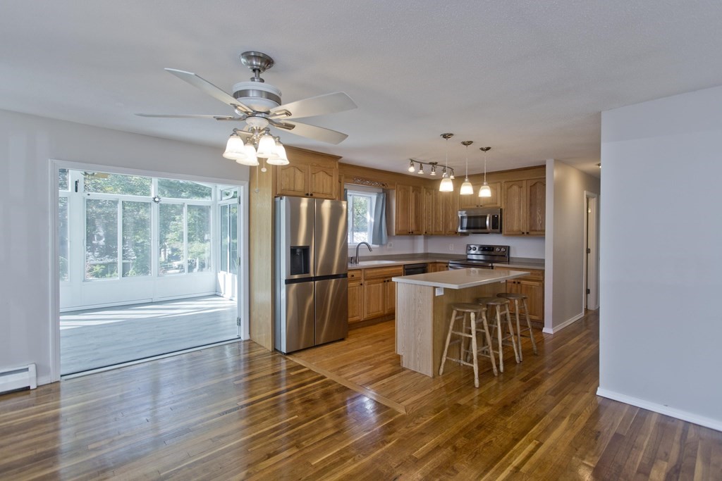 61 Arbor Road Enfield, CT 06082 - Photo 7 of 39 a kitchen with a refrigerator a stove cabinets and wooden floor
