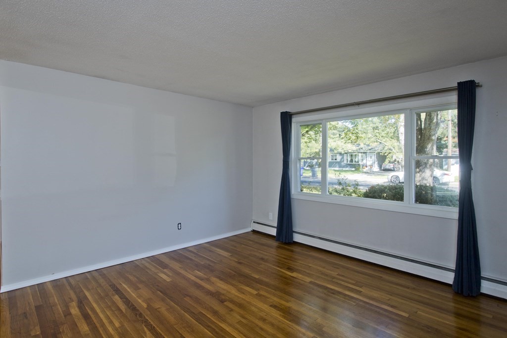 61 Arbor Road Enfield, CT 06082 - Photo 8 of 39 a view of empty room with wooden floor and fan