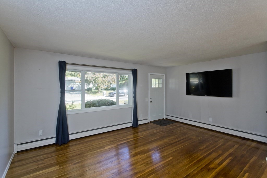 61 Arbor Road Enfield, CT 06082 - Photo 9 of 39 an empty room with wooden floor and windows