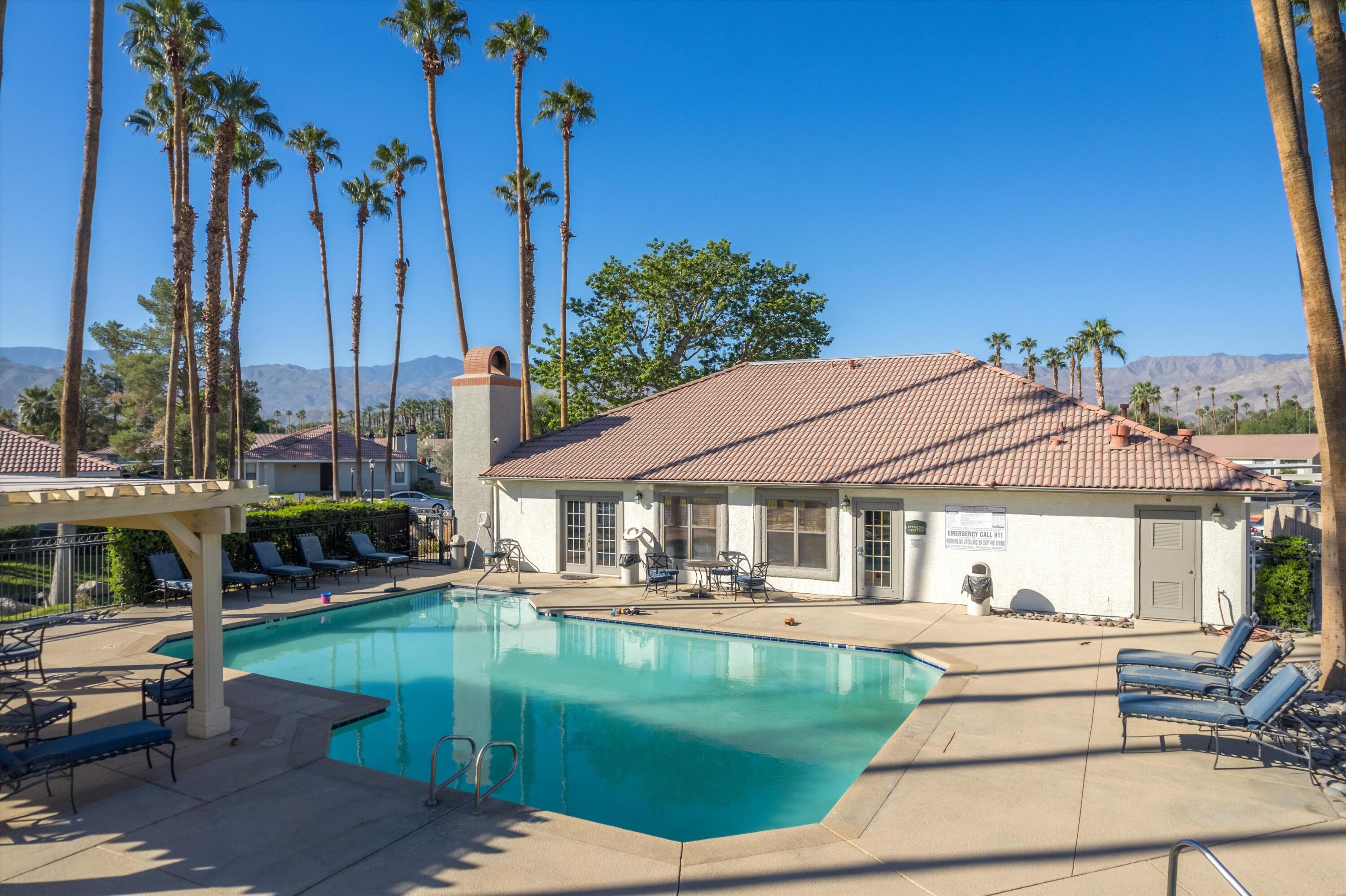 43376 Cook Street, Unit 38 Palm Desert, CA 92211 - Photo 25 of 33 a front view of a house with a garden