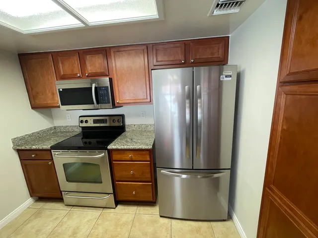a kitchen with a refrigerator sink and microwave