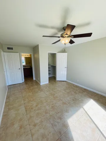 a view of an empty room with a ceiling fan