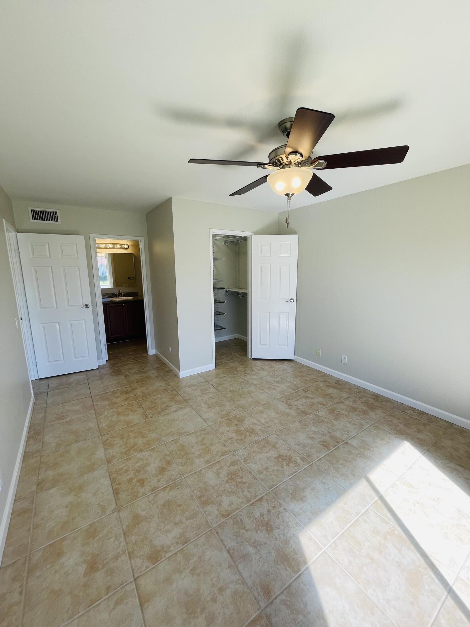 43376 Cook Street, Unit 38 Palm Desert, CA 92211 - Photo 8 of 33 a view of an empty room with a ceiling fan
