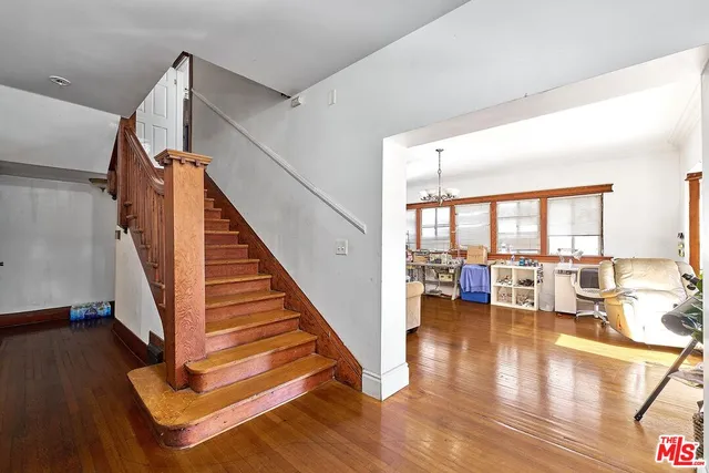 a view of a living room with wooden floor and furniture