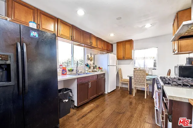 a kitchen with sink cabinets and wooden floor