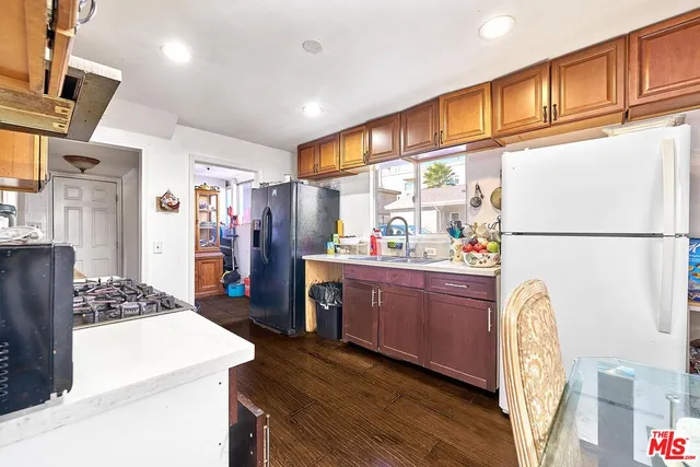 a kitchen with stainless steel appliances granite countertop a refrigerator and a stove top oven