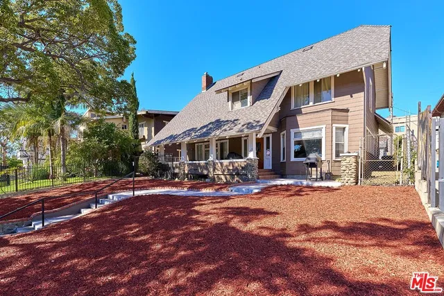 a front view of a house with a big yard