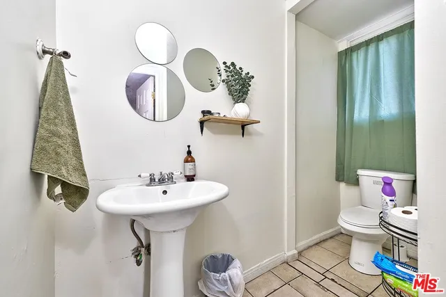 a bathroom with a sink toilet and a mirror