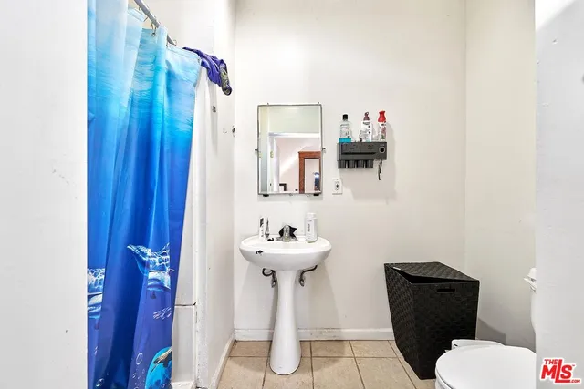 a bathroom with a sink mirror and toilet
