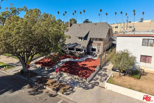 an aerial view of a house with a yard basket ball court and outdoor seating