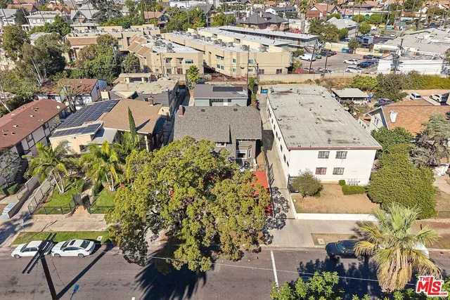 an aerial view of residential houses with outdoor space