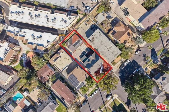 an aerial view of a house with a yard and entryway