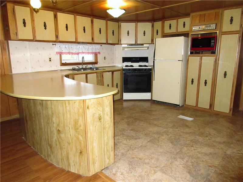 1000 Winfield Road Cabot, PA 16023 - Photo 4 of 24 Nice sized kitchen with penninsula, open to dining room and living room.