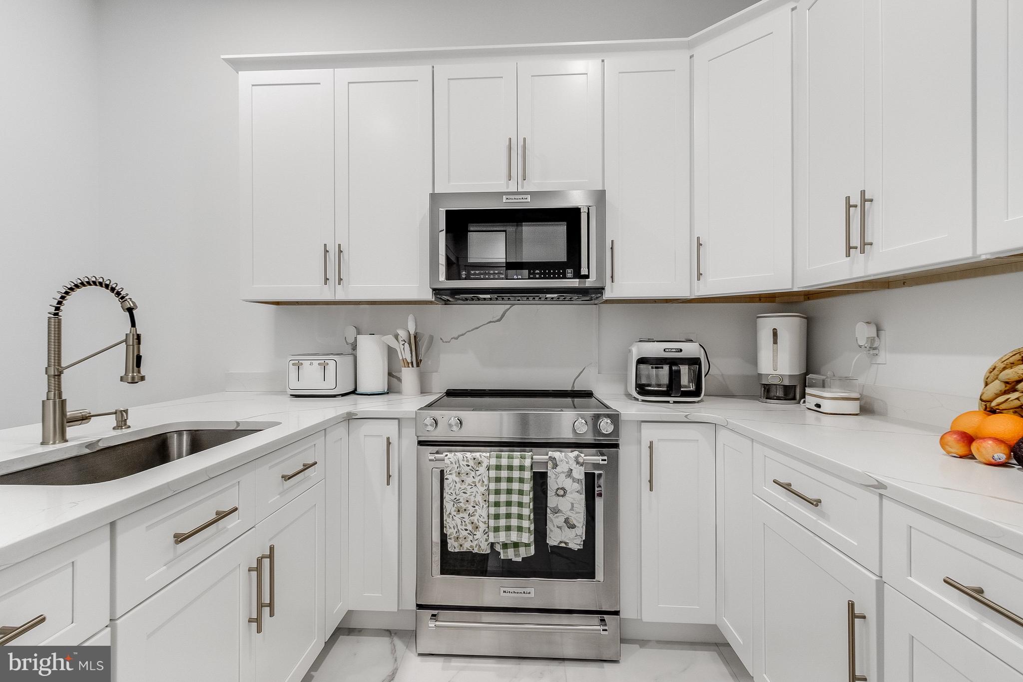 20157 West Piney Grove Road Georgetown, DE 19947 - Photo 21 of 104 a kitchen with stainless steel appliances granite countertop a sink a stove and cabinets