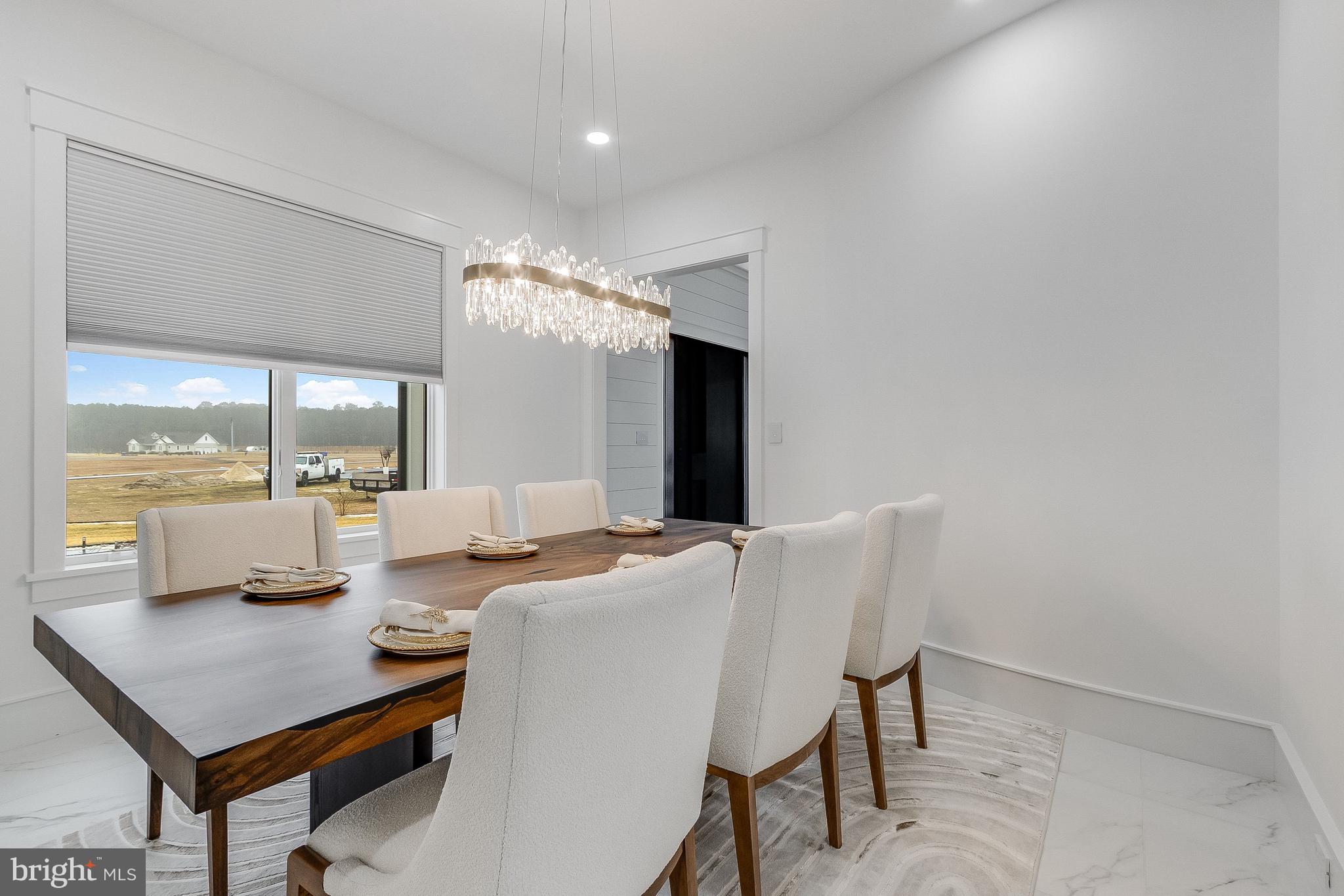20157 West Piney Grove Road Georgetown, DE 19947 - Photo 25 of 104 a view of a dining room with furniture and chandelier