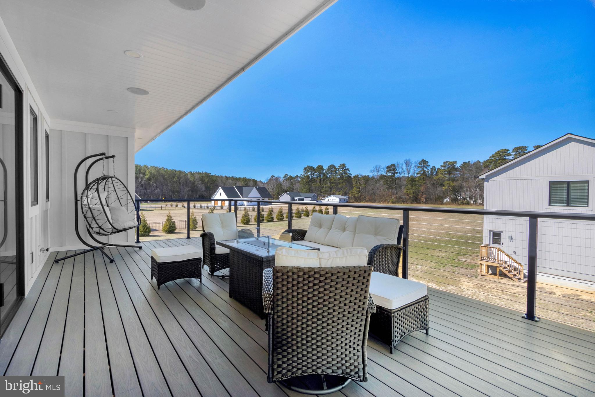 20157 West Piney Grove Road Georgetown, DE 19947 - Photo 46 of 104 a balcony with wooden floor table and chairs