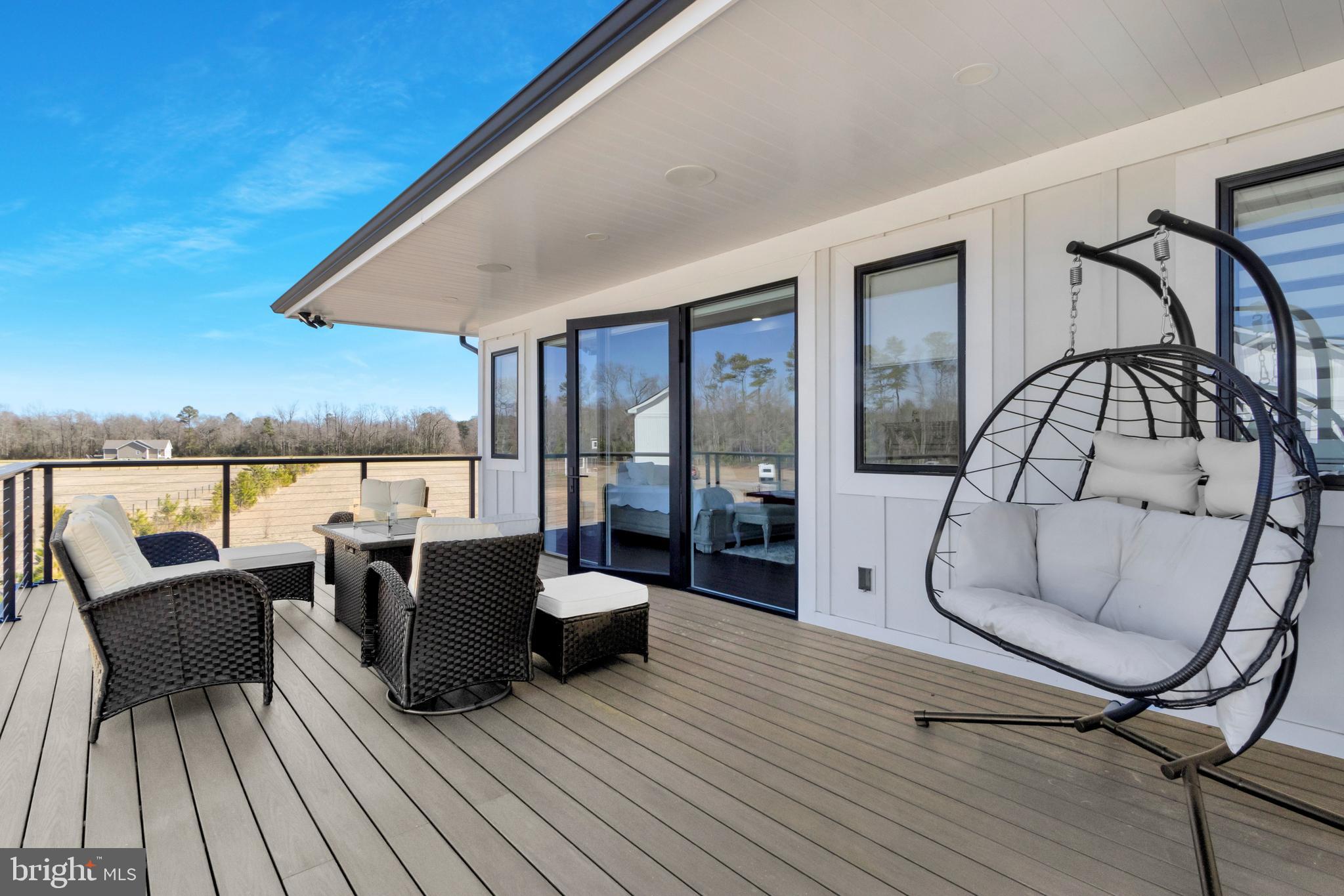 20157 West Piney Grove Road Georgetown, DE 19947 - Photo 47 of 104 a view of a roof deck with table and chairs a barbeque with wooden floor and fence