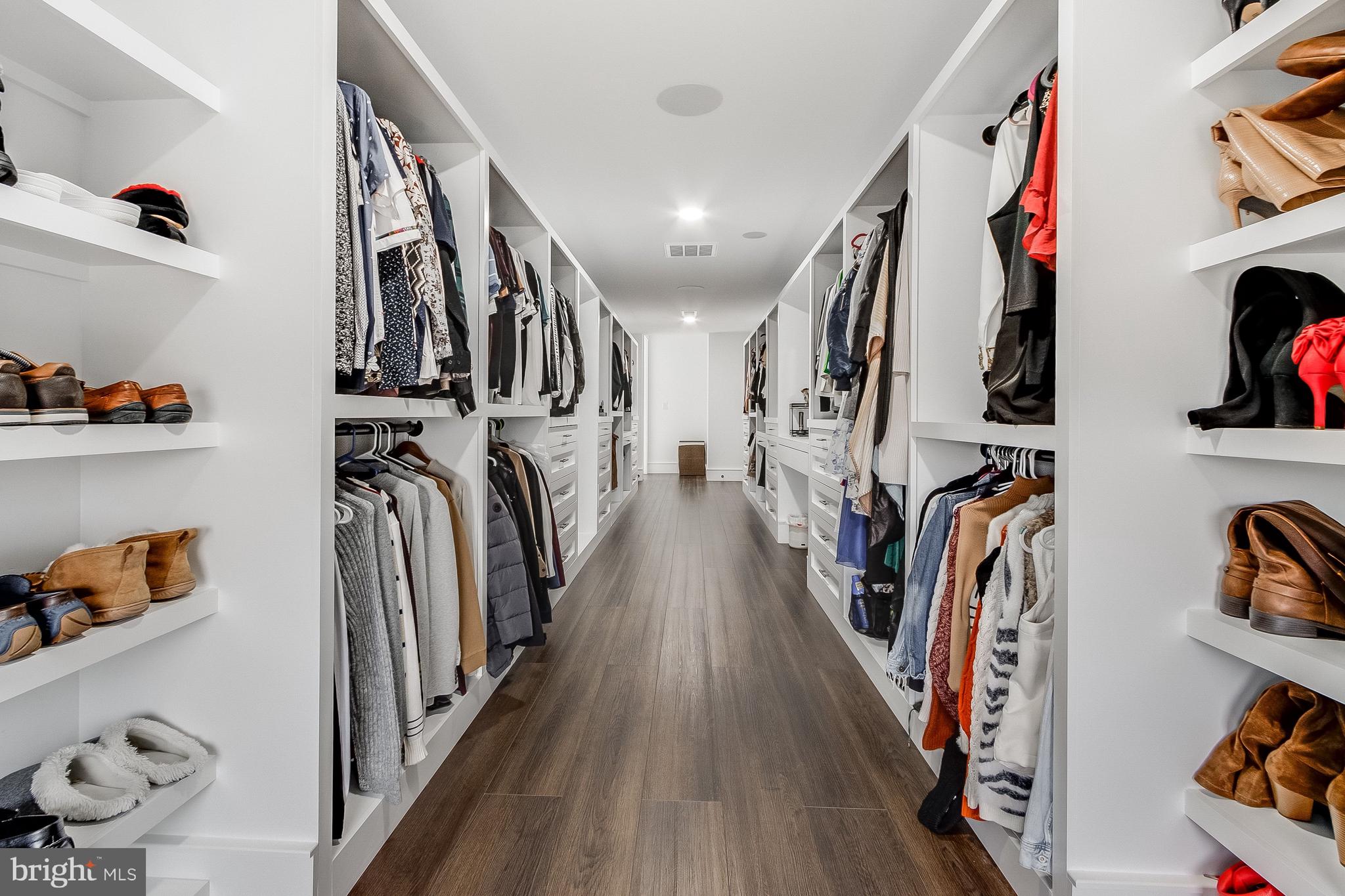 20157 West Piney Grove Road Georgetown, DE 19947 - Photo 61 of 104 a view of walk in closet with clothes and shoes