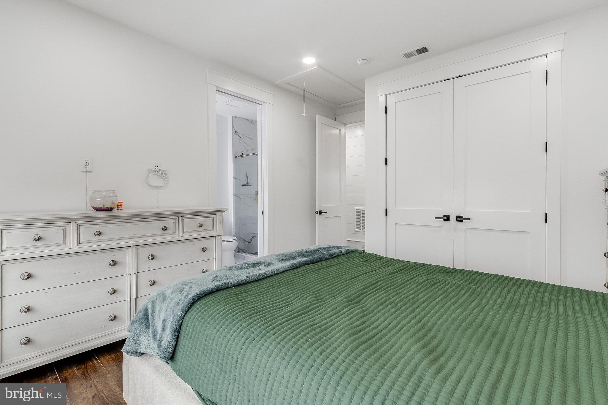 20157 West Piney Grove Road Georgetown, DE 19947 - Photo 64 of 104 a bedroom with a bed and a dresser