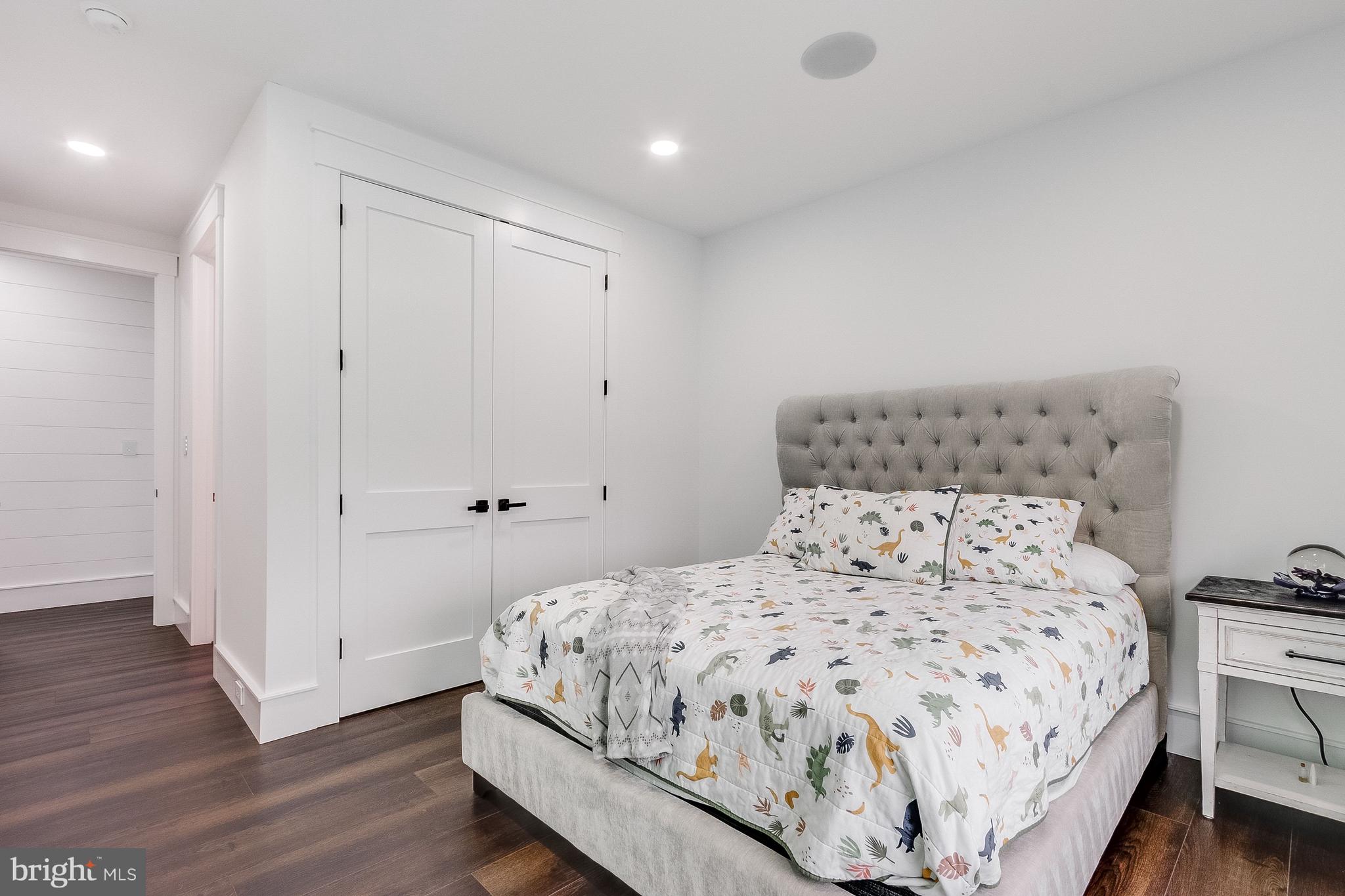 20157 West Piney Grove Road Georgetown, DE 19947 - Photo 69 of 104 a bedroom with a bed and wooden floor