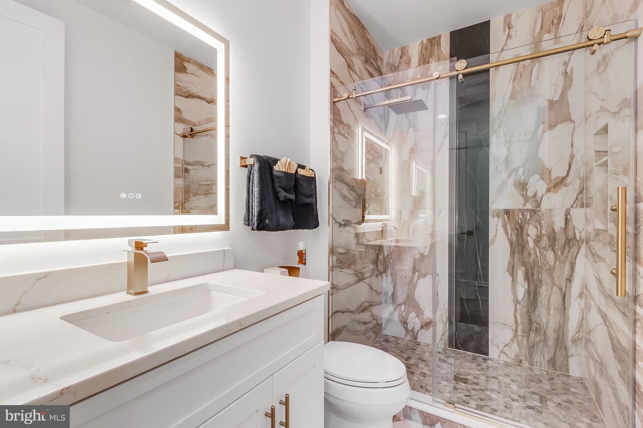 20157 West Piney Grove Road Georgetown, DE 19947 - Photo 70 of 104 a bathroom with a sink toilet vanity and shower