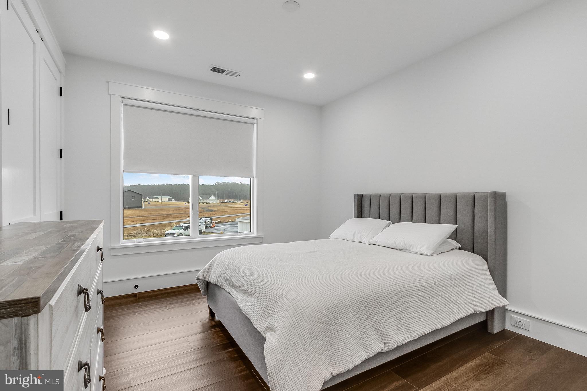 20157 West Piney Grove Road Georgetown, DE 19947 - Photo 75 of 104 a bedroom with a large bed and a window