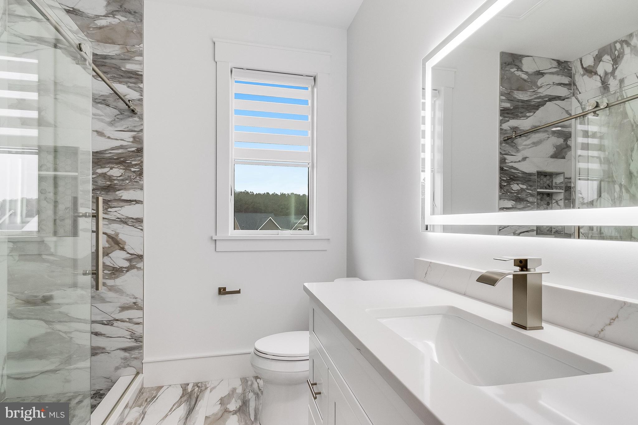 20157 West Piney Grove Road Georgetown, DE 19947 - Photo 76 of 104 a bathroom with a sink a toilet and window