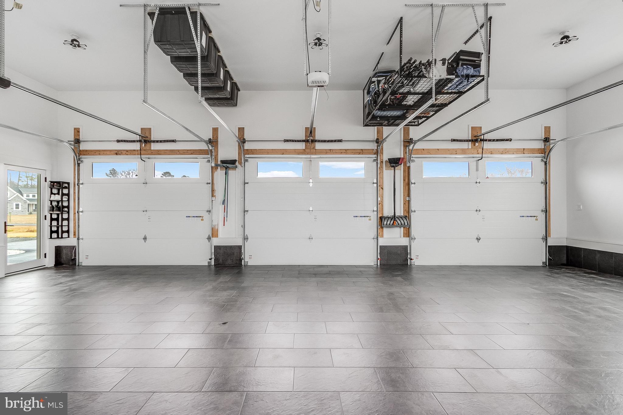 20157 West Piney Grove Road Georgetown, DE 19947 - Photo 79 of 104 Attached 3 car Garage - tile floor and storage