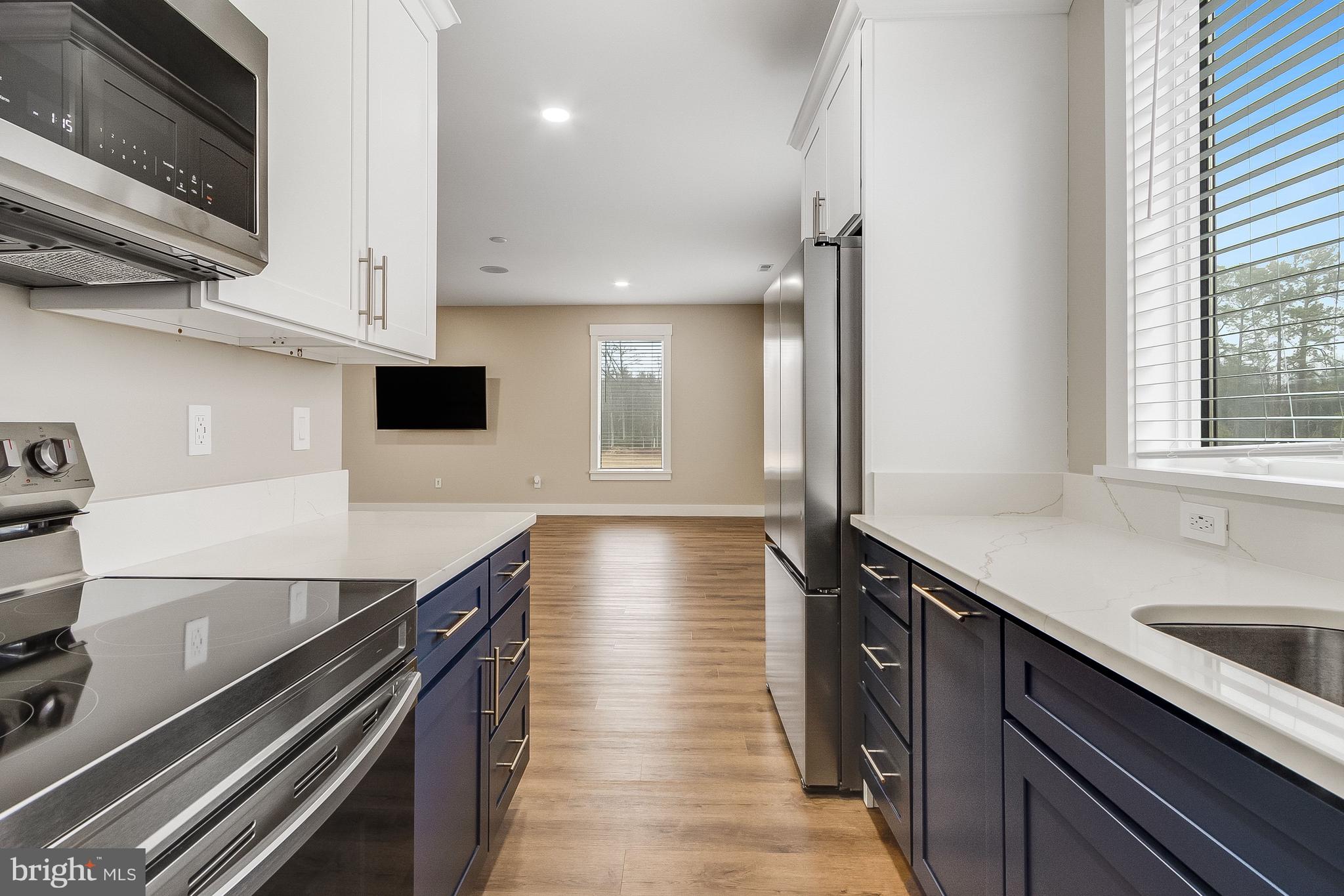 20157 West Piney Grove Road Georgetown, DE 19947 - Photo 85 of 104 a kitchen with stainless steel appliances a sink stove and cabinets