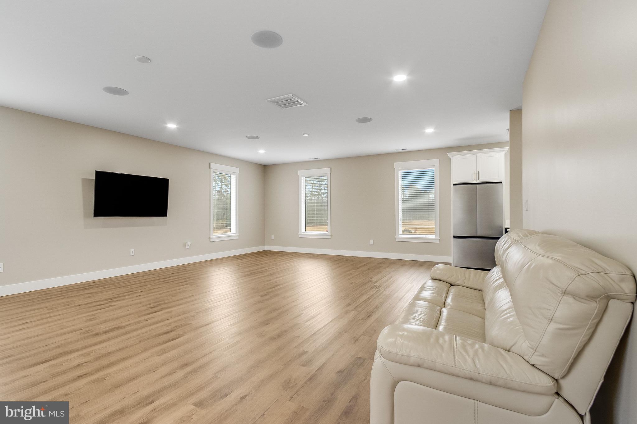 20157 West Piney Grove Road Georgetown, DE 19947 - Photo 87 of 104 a living room with furniture and a flat screen tv
