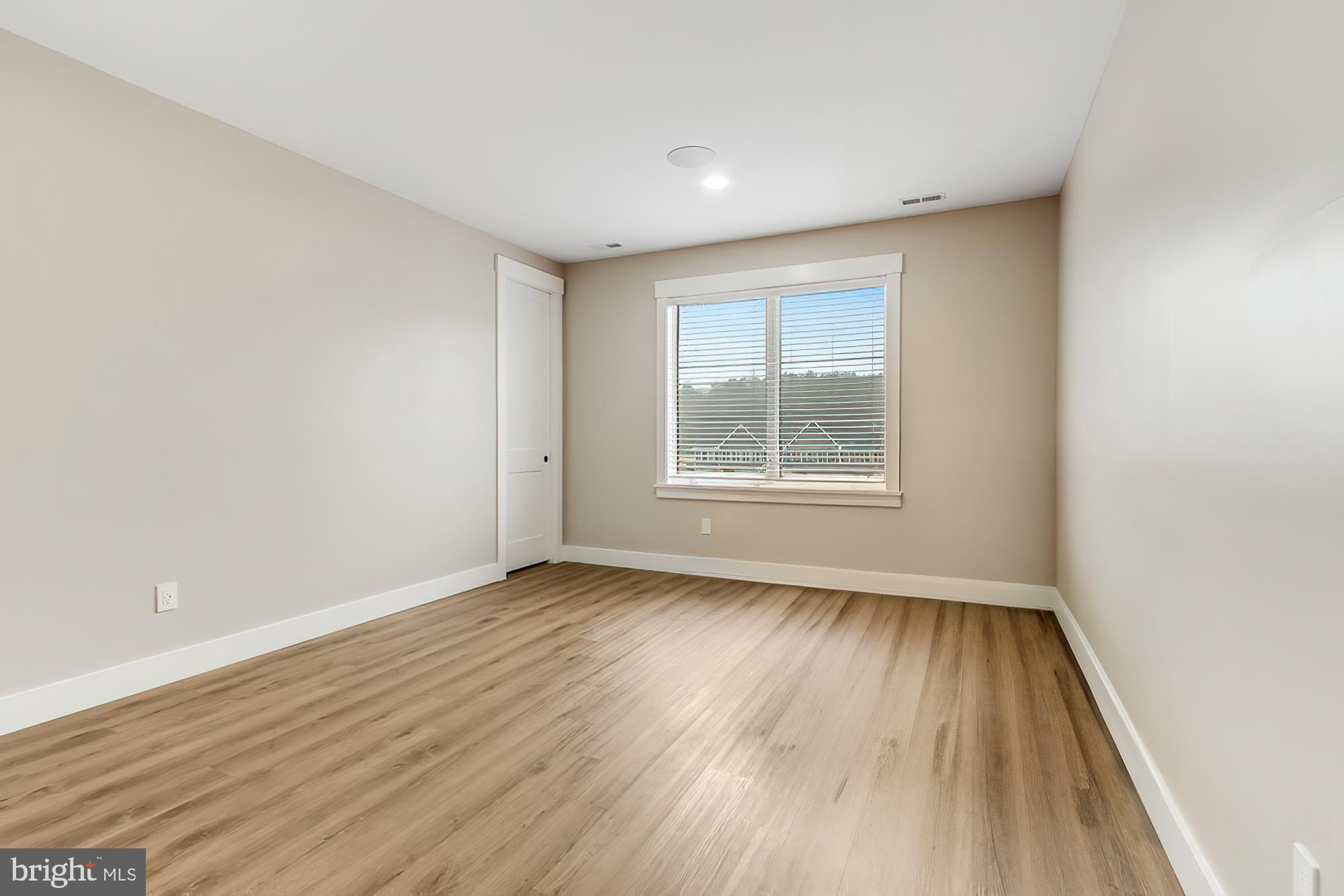 20157 West Piney Grove Road Georgetown, DE 19947 - Photo 89 of 104 an empty room with wooden floor and windows